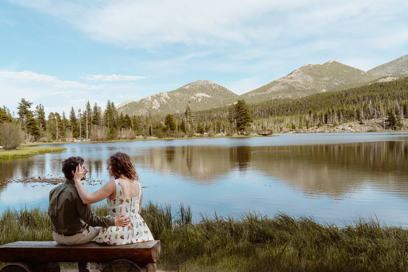 Bride and groom embracing in a mountain meadow, Motus elopement in Rocky Mountain National Park