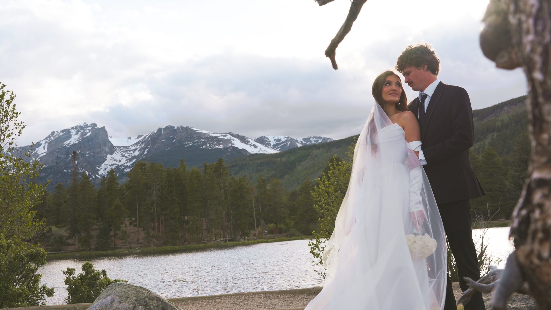 Bride and groom embracing at a rocky overlook, still from a Motus wedding film, Rocky Mountain National Park