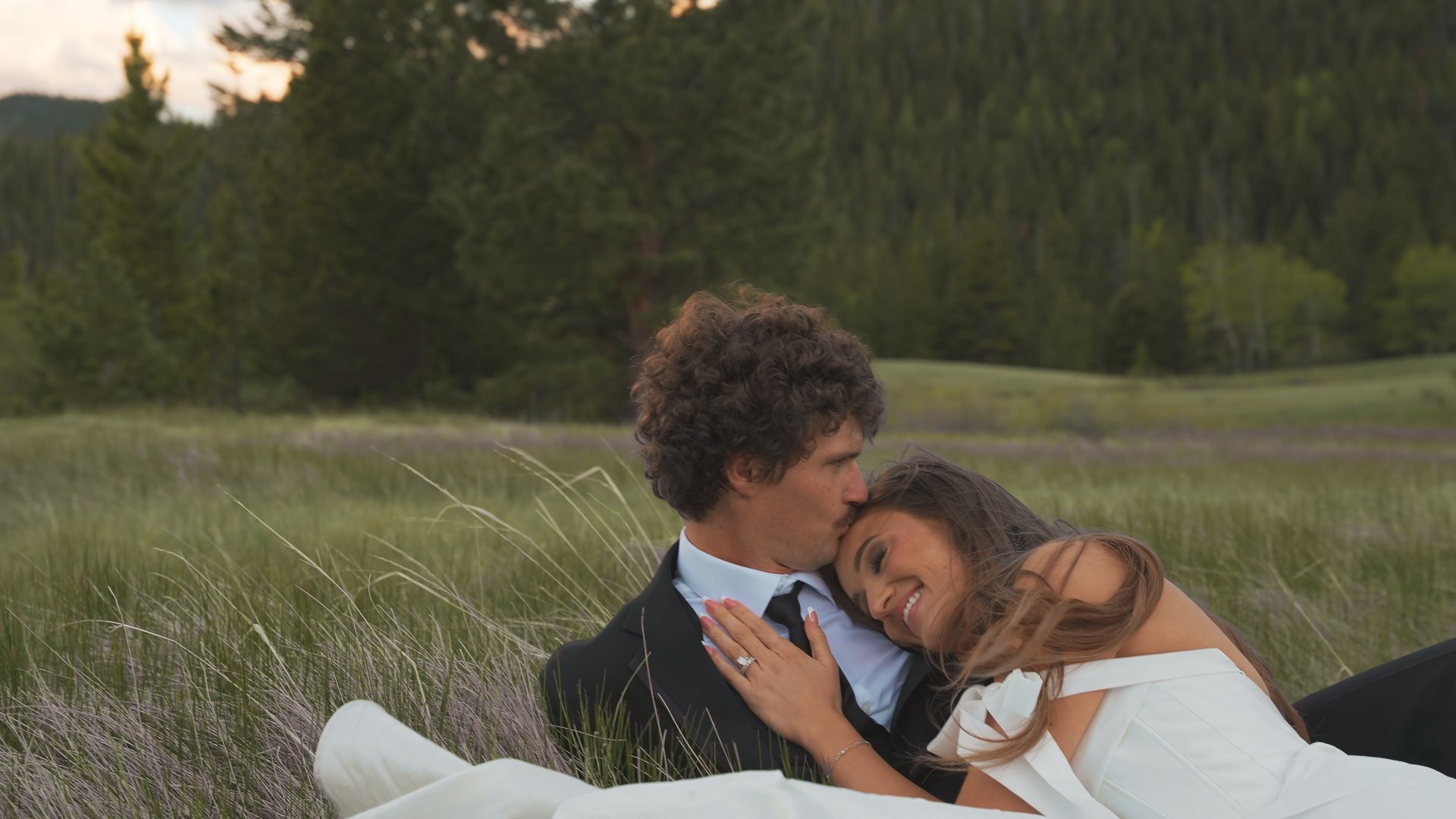 Couple in meadow grass at dusk, still from a Motus wedding film, Rocky Mountain National Park