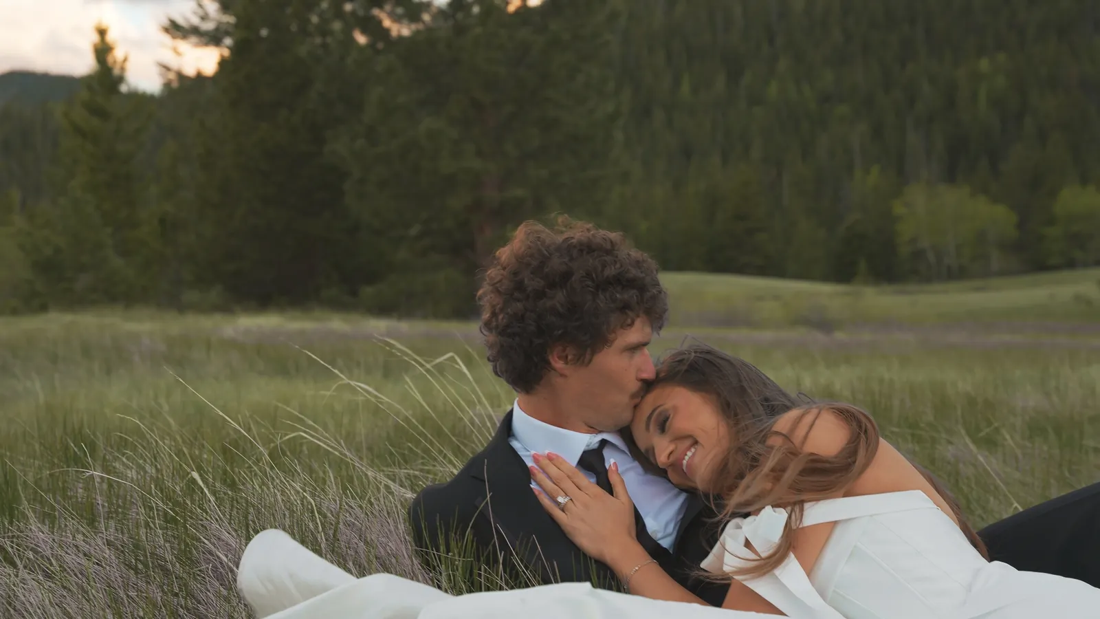 Couple in meadow grass at dusk, still from a Motus wedding film, Rocky Mountain National Park