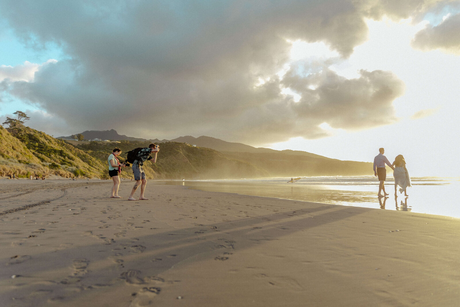 Brandon and Aby shooting a couple on the beach at golden hour